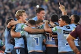 NSW Blues players celebrate winning Game 2 of the 2018 State of Origin series against Queensland.