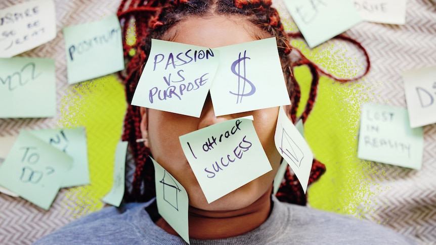 A woman with curly hair is surrounded by post-it notes with postive messages, such as "I attract success".