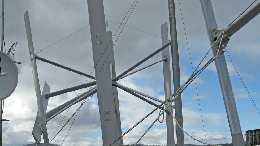 Ropes hold down a broken wind turbine on top of the Hobart Marine Board building