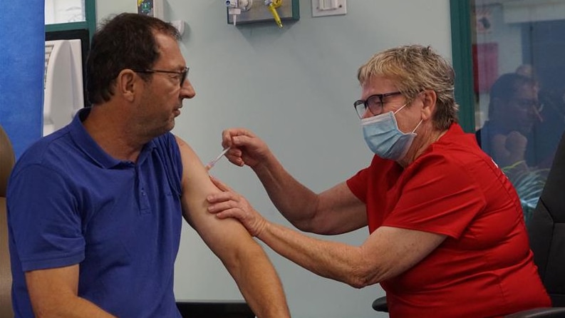 A man receives a coronavirus vaccine injection.