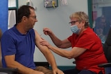 A man receives a coronavirus vaccine injection.