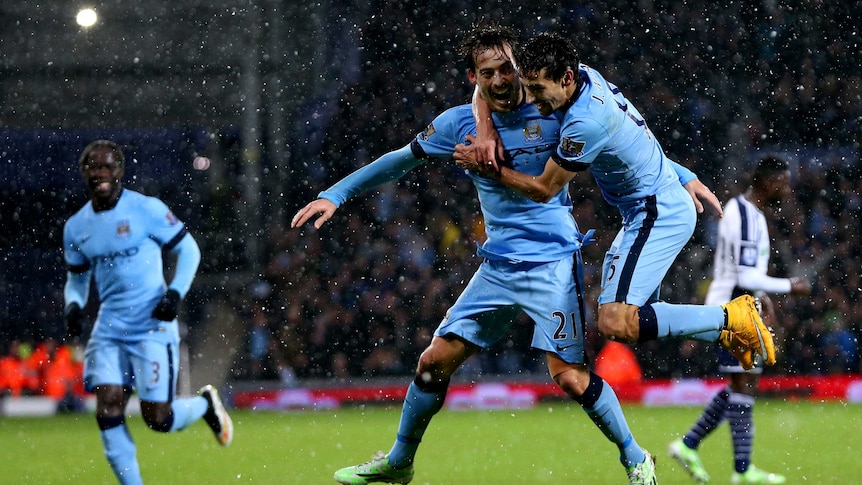 David Silva celebrates with Jesus Navas after scoring for Manchester City against West Brom.