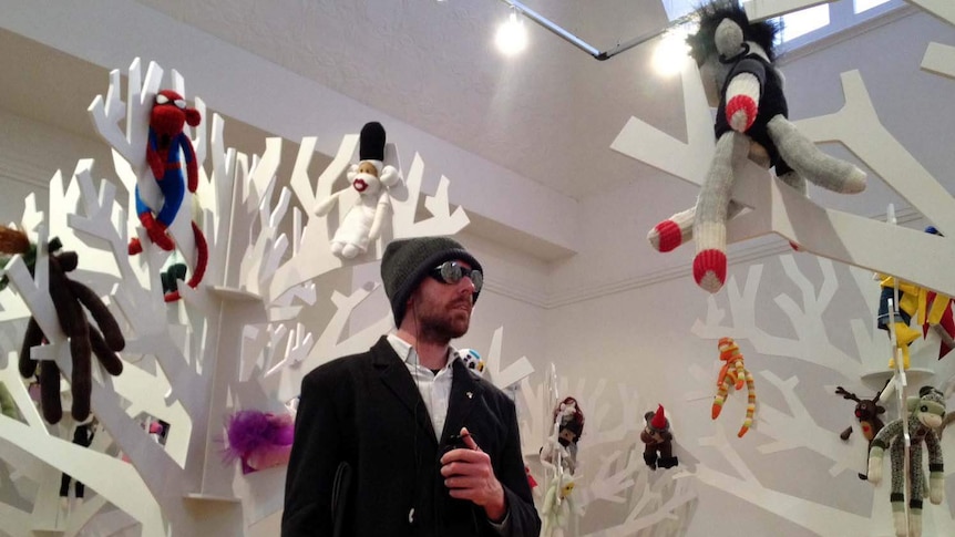 Blind Tasmanian artist James Newton with his collection of sock monkey creations.