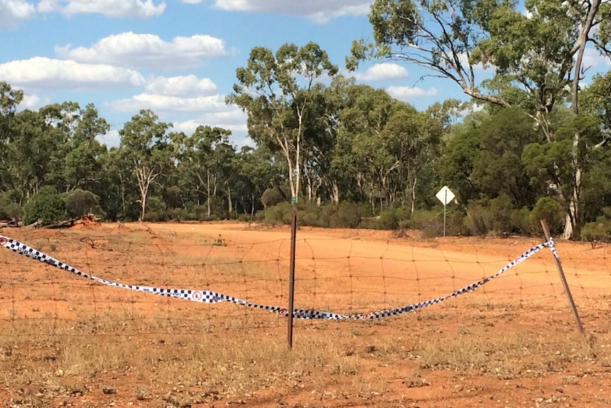 Dirt track that leads into bushland that's been cordoned off by police