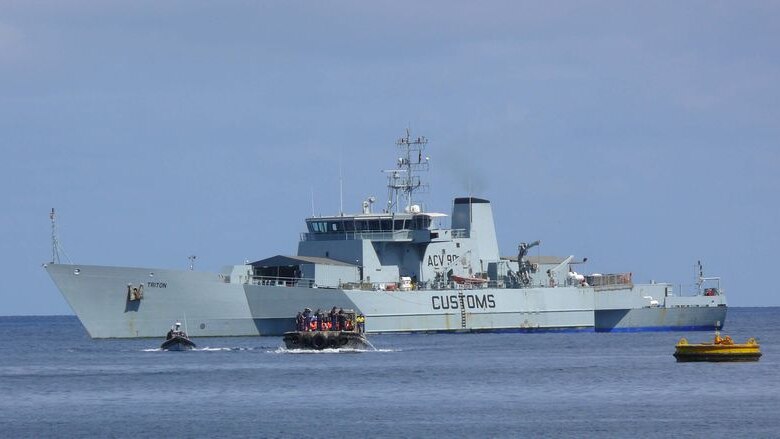 A Customs boat sits off the coast of Christmas Island.
