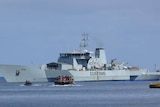 A Customs boat sits off the coast