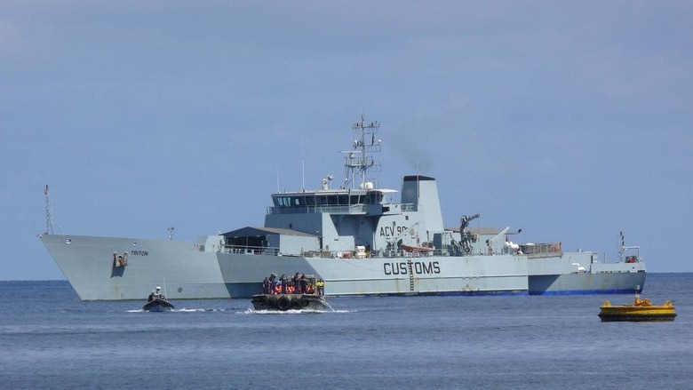 A Customs boat sits off the coast