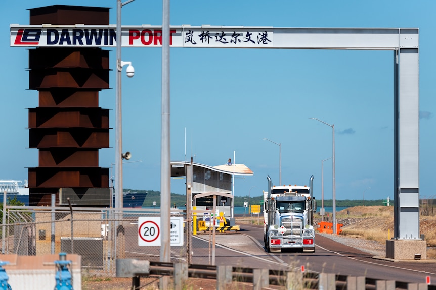A truck drives out of the entrance of the Darwin Port on a sunny day.