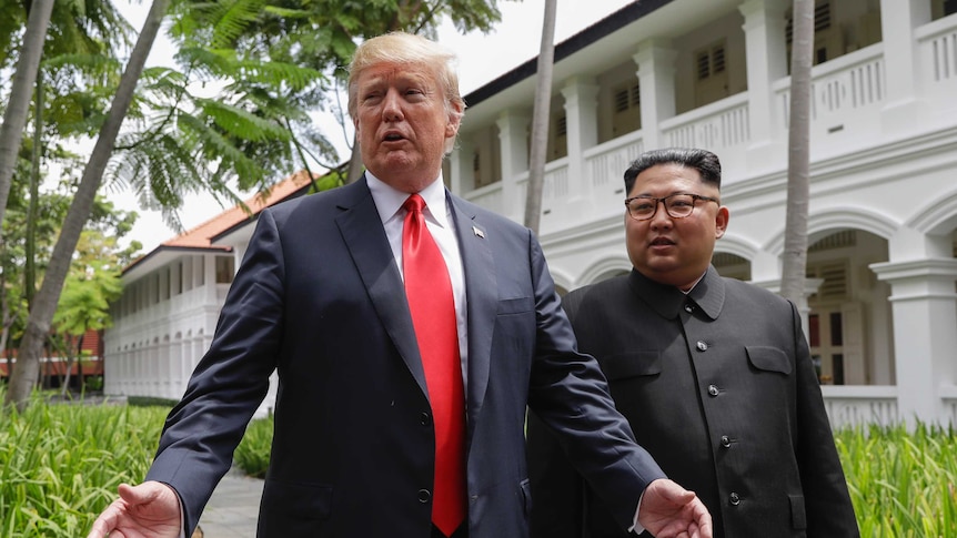 Donald Trump and Kim Jong-un walking together after lunch in Singapore.