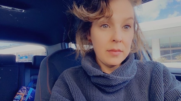 A profile image of Monique in her car