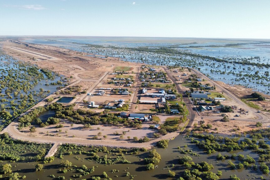 An aerial shot of a vast flood in the outback that has isolated a small town.