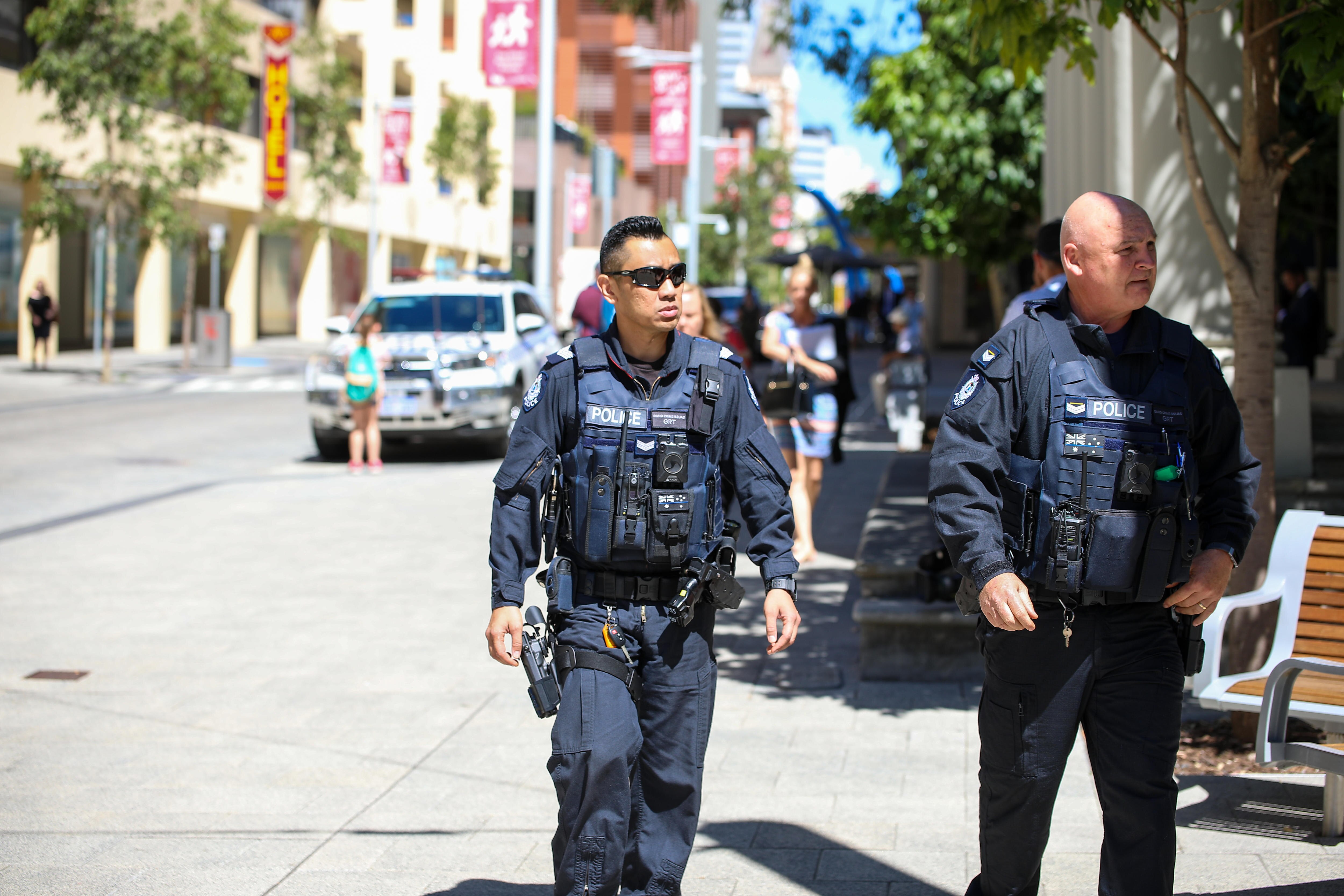 Two WA Police gang crime squad officers outside the District Court building in Perth.