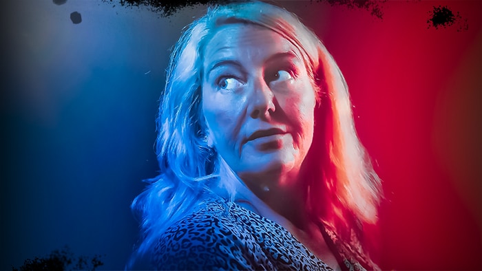Nicola Gobbo looks backwards with red and blue light to both sides of her