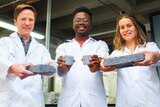 Students at University of Cape Town holding urine-produced bricks