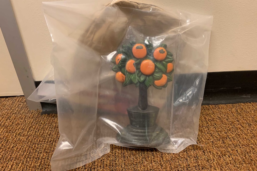 A tree-shaped doorstop in a plastic evidence bag