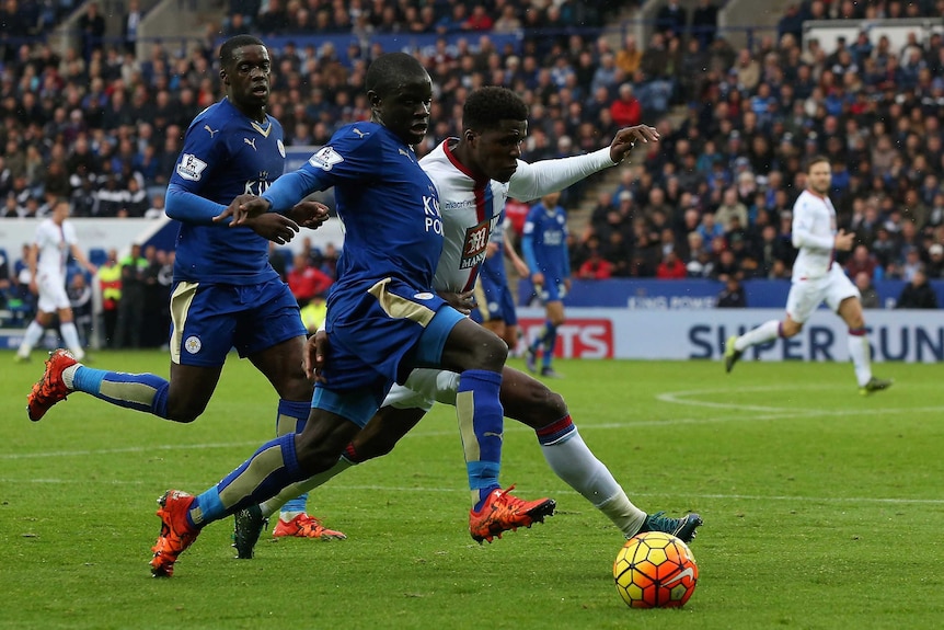 N'Golo Kante battles for the ball with Wilfried Zaha