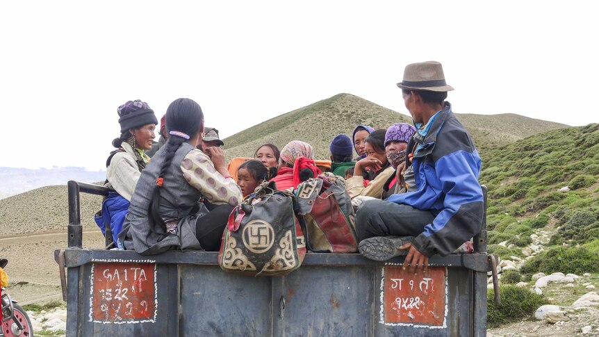 People cram into a trailer in Mustang, Nepal