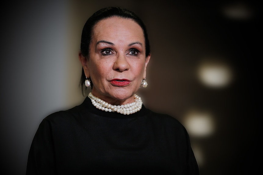 Linda Burney wearing a black top and pearl necklace.