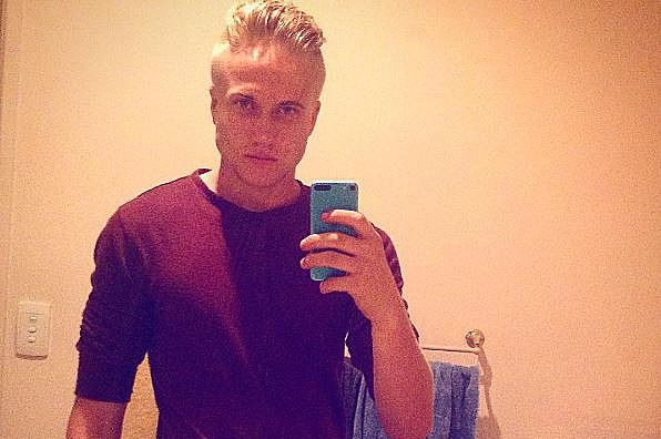 Trent Thorburn takes a selfie on his mobile phone in the mirror