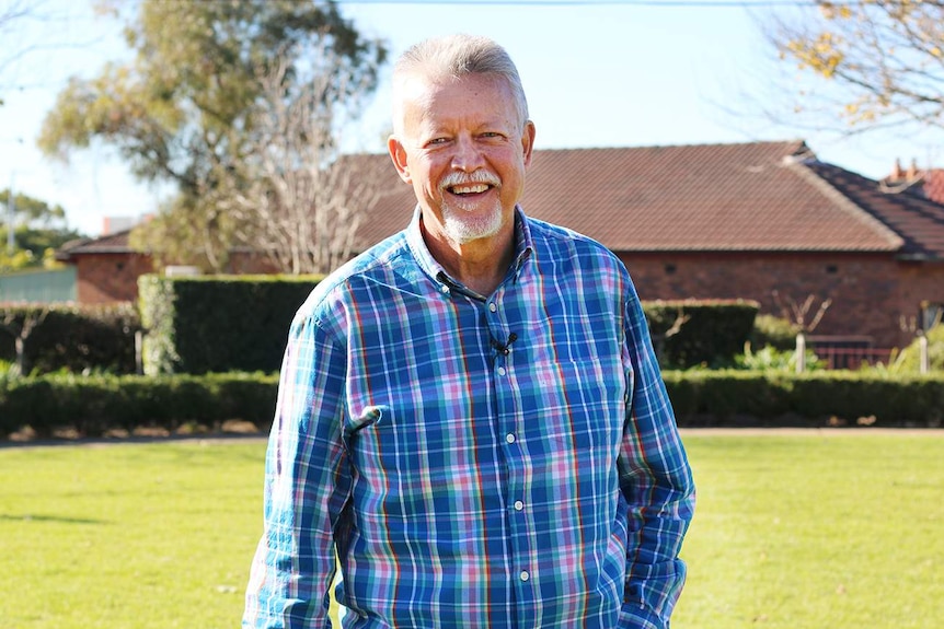 A man smiles at the camera.