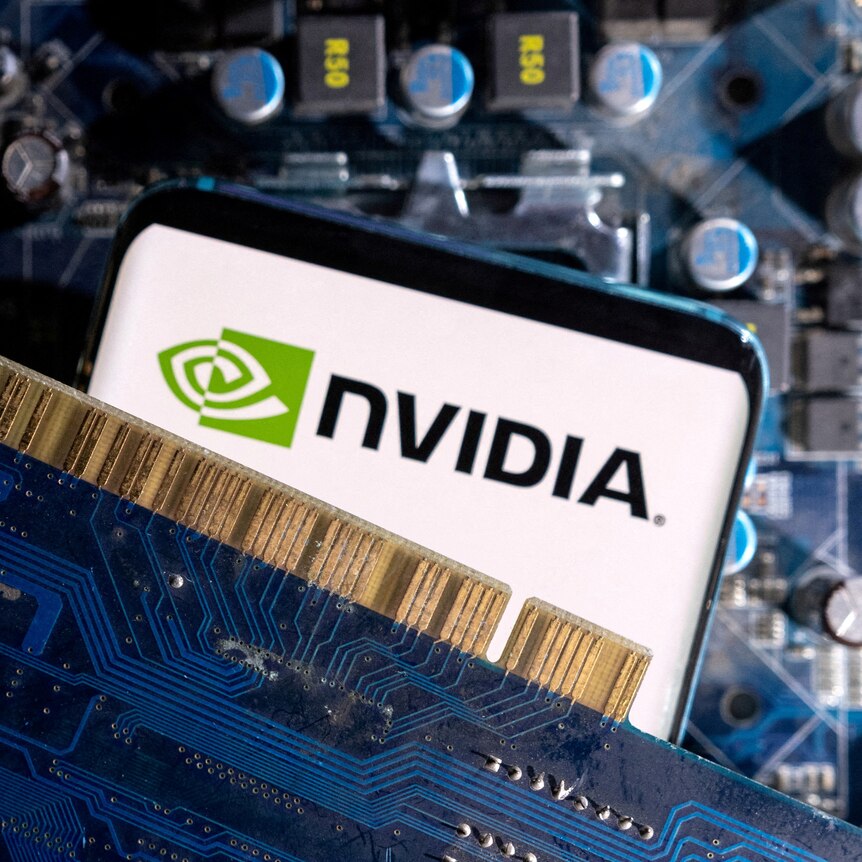 A close-up of a smartphone displaying an Nvidia logo, sandwiched between two computer parts. 