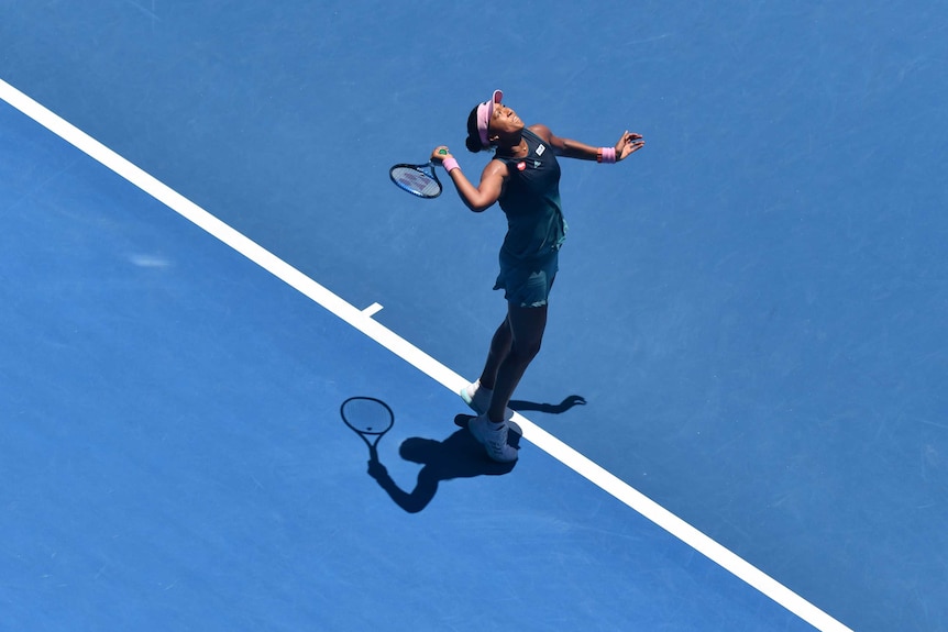 An overhead shot of Naomi Osaka serving.