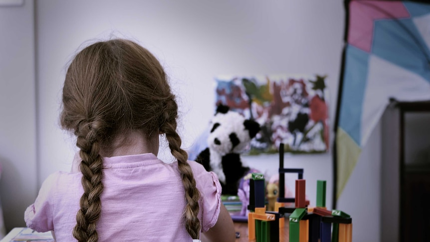 A child playing with toys.