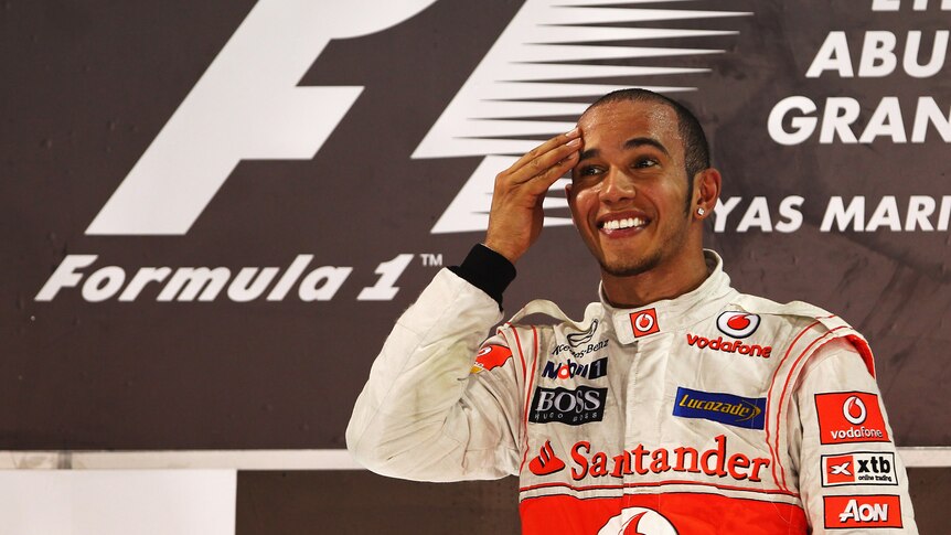 Lewis Hamilton wiping his brow on the podium after win in Abu Dhabi