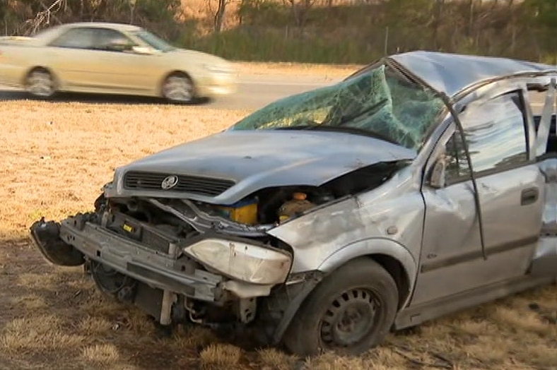 A silver car with a crushed bonnet and smashed windscreen.