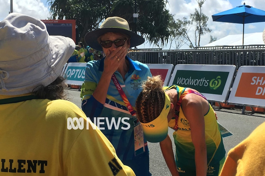 Claire Tallent hugs an official after being disqualified