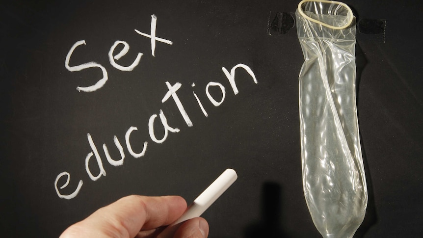 Condom fixed on a blackboard with tape.