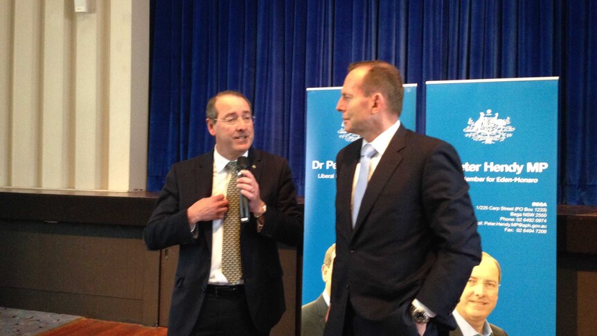 Eden-Monaro MP Peter Hendy and Prime Minister Tony Abbott speaking at the Cooma Ex-Services Club on Friday.