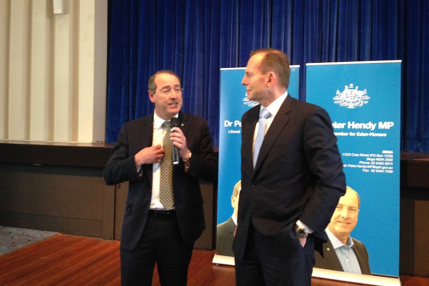 Eden-Monaro MP Peter Hendy and Prime Minister Tony Abbott speaking at the Cooma Ex-Services Club on Friday.