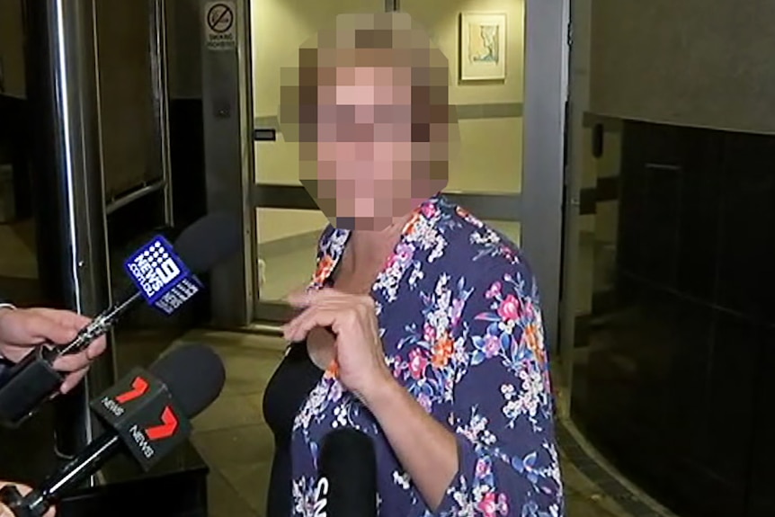 A woman (face pixelated) leaving a Brisbane court