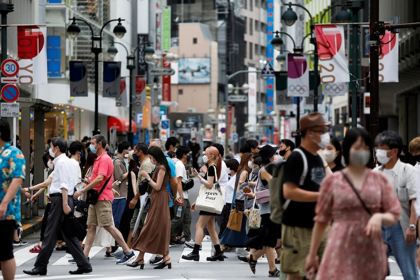 People walk at a crossing in Shibuya shopping area.