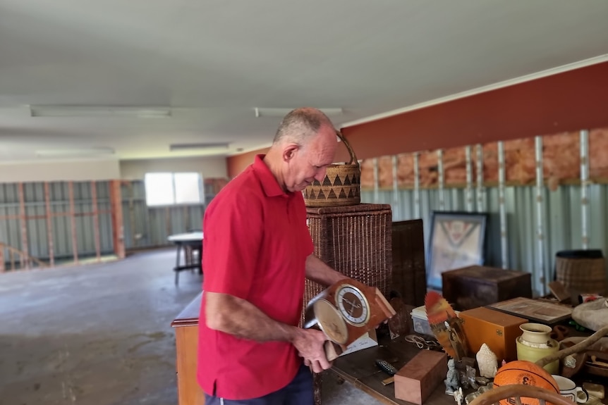 Richmond Valley Mayor Robert Mustow going through flood damaged items.