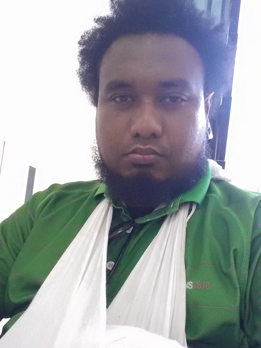 PNG journalist Jason Wuri with his arm in a sling.