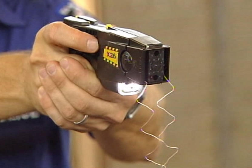 Close-up of police officer firing Taser in Canberra. August 2011.