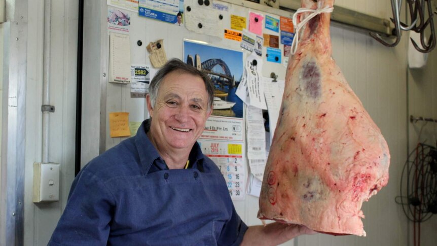 Binalong butcher Mick del Santo with a beef carcass