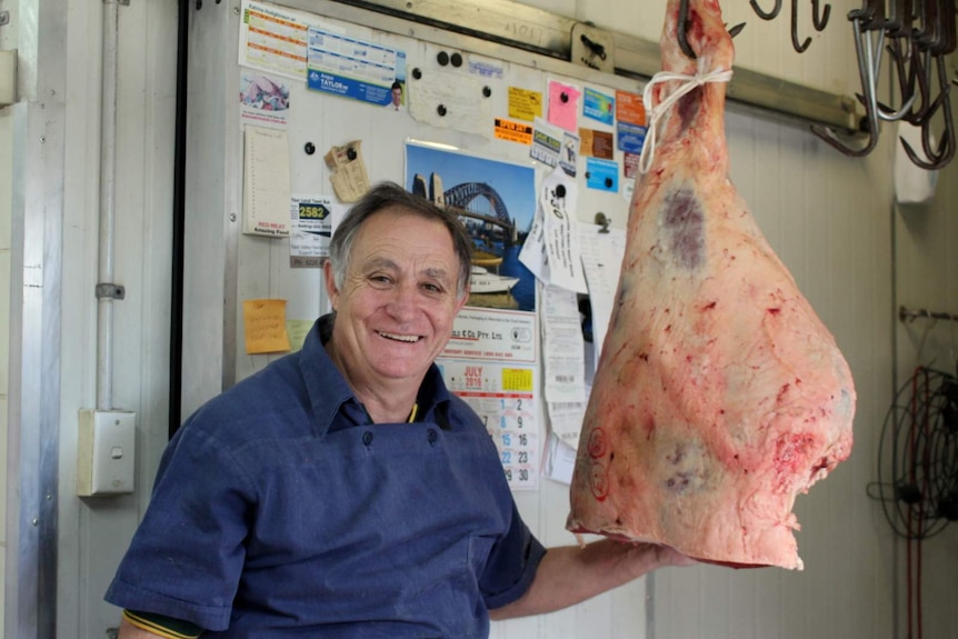 Binalong butcher Mick del Santo with a beef carcass
