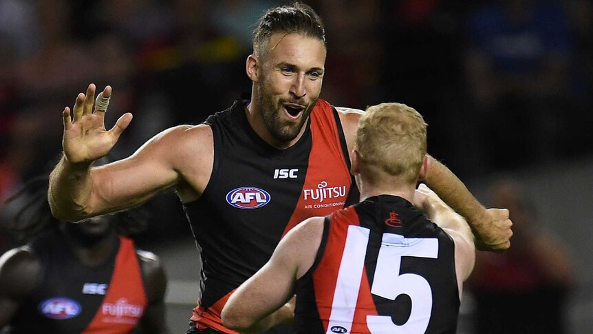 Cale Hooker (L) reacts after kicking a goal to put Essendon in front against Adelaide at Docklands.