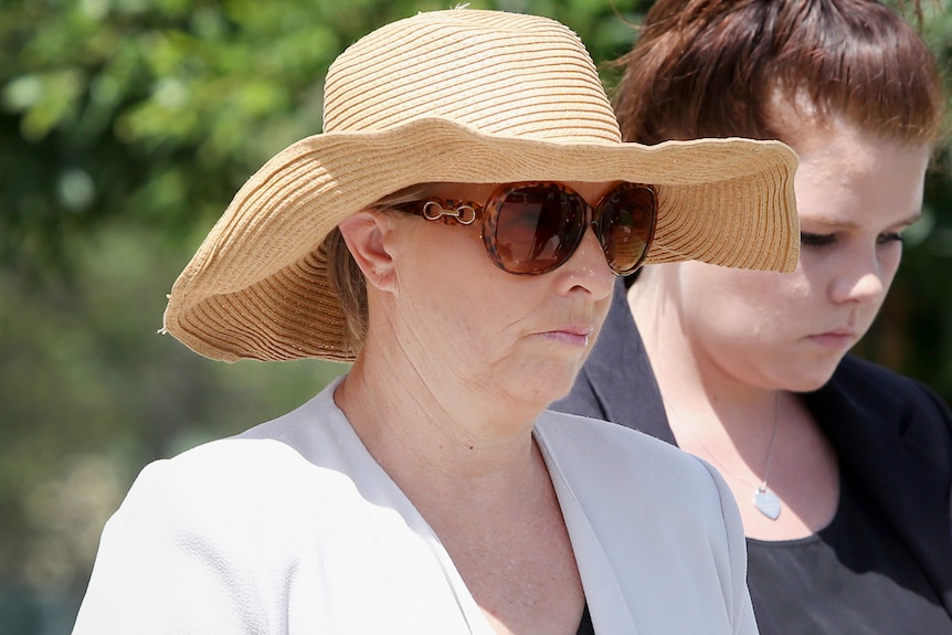 Julene Thorburn arrives at the Beenleigh Court wearing a straw hat and large sunglasses.