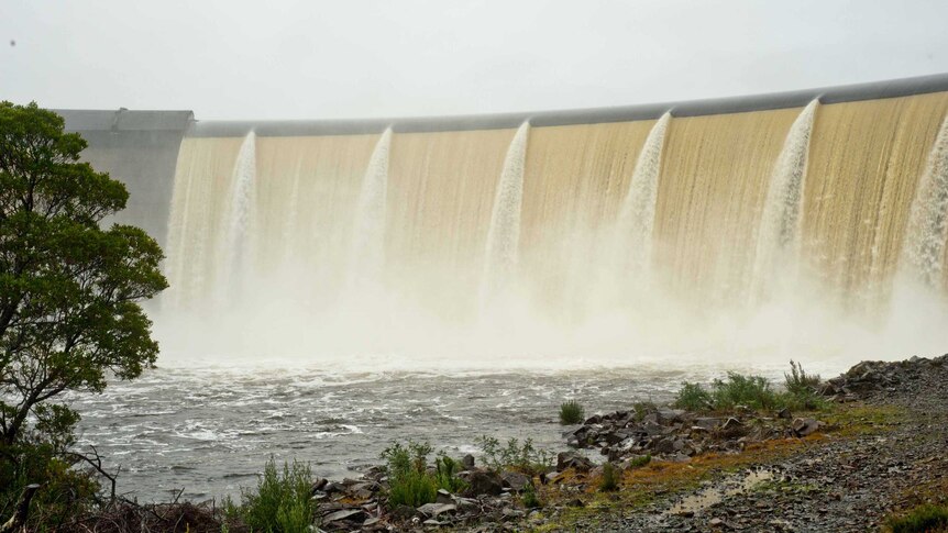 Water flows over the wall of the dam powering the Repulse Power Station.