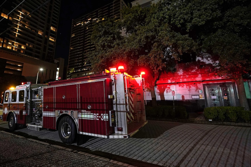 A fire truck is positioned outside the Chinese Consulate in Houston.