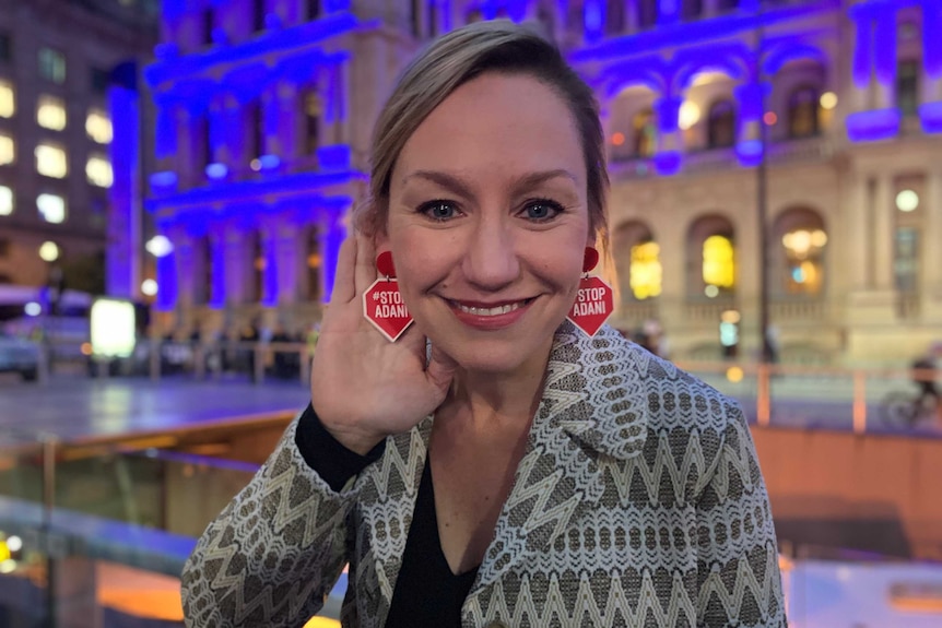 Donning Anti-Adani earrings Larissa Waters addresses the hundreds of people in the crowd.