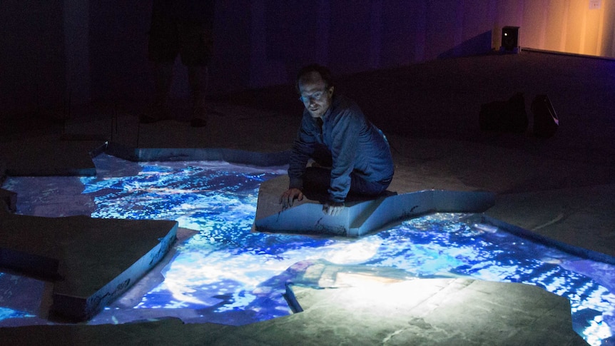 Artist Sohan Ariel Hayes surveys his creation, Descent Into Yarragadee