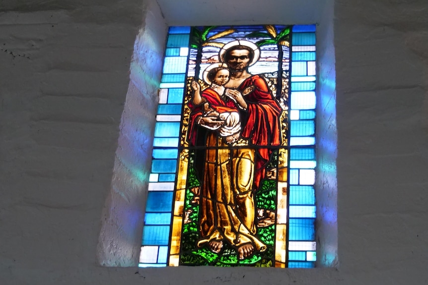 This is a stained glass window of Joseph and baby Jesus.