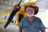 Ross Smith stands in front of restored plane in Rolleston workshop, April 2016.