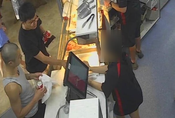 CCTV footage shows two men placing an order at Weipa Bakery. 