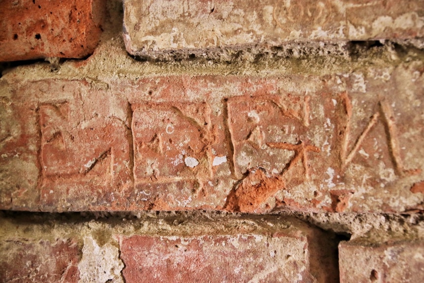 Letters etched on bricks